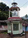 From a distance, the hindu and christian shrines are nearly indistinguishable.  They are all over the place and contain statutes of some deity or saint.  This is a christian one.  Drivers sometimes stop and throw a few rupees in the box and make obeisance during a trip.