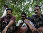 Two men and a palm wine tapper.  Guess which one is the tapper.  He looks just the same as the tappers in Liberia.