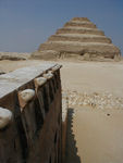 The pyramid and part of a wall featuring a frieze of cobras.  The cobra, or uraeus, was a symbol of lower Egyptian royalty