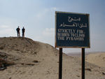 No, they are not standing on a pyramid
