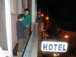 Throwing streamers off the balcony.  Maggie made some origami animals for a cafe owner, and he rewarded the children with noisemakers and streamers.  