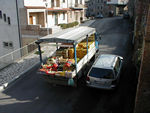 The fruit truck.  One of several businesses that drive the streets with a loudspeaker announcing their services.  The dry cleaner is another.