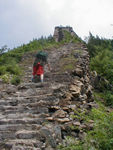 Along the wall are towers, offset to the attackers' side slightly.  The idea was to get a clearer shot at bad guys who might try to climb the wall with ladders.  Shih huang-ti built the wall to protect his kingdom from the Hsiung-nu.  The Hsiung-nu, historically speaking, are a curious people.  They first appear in Chinese historical records about the 5th century BC and disappear from the records in about the 5th century AD.  Some historians believe they were the Huns,who invaded the Roman Empire in the 5th century. The Hsiung-nu became a real threat to China after the 3rd century BC, when they formed a far-flung tribal confederation under a ruler known as the shan-yü, the rough equivalent of the Chinese emperor's designation as the t'ien-tzu ("son of heaven"). They ruled over a territory that extended from western Manchuria (Northeast Provinces) to the Pamirs and covered much of present Siberia and Mongolia. The Hsiung-nu were fierce mounted warriors who were able to muster as many as 300,000 horseback archers on their periodic intrusions into North China, and they were more than a match for the much less maneuverable chariots of the Chinese. The completion of the Great Wall along the whole of China's northern frontier during the Ch'in dynasty (221-206 BC) slowed but did not stop the Hsiung-nu. 