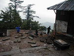 On monkey patrol.  The kids enjoyed chasing the monkeys around the outside of the monastery and occasionally through the monastery's halls.  At least the front of the place is being reconstructed.  We watched a stonecarver working on a pair of neat stone lions that will grace the front.  In the meantime, one enters through a muddy courtyard.