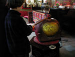 Maggie banging on a gong.