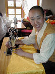 A nun working on a garment.  She called us in to chat.