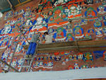 Tote climbing up to help repaint buddhas