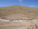 Our buses on the road amidst a barren landscape