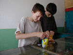 The kids discovered these noodle packages by watching the locals.  You don't add water.  You simply crush the noodles and add the flavor packet. Then you eat the mixture cold.
