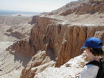 Maggie looking off a cliff.  A guardhouse built to deter terrorists is on the next ridge over.