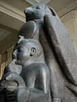 Ramses II and Horun.  This shows the royal child Ramses being protected by a huge falcon.  The sculpture is a sort of visual pun or hieroglyph of the king's name:  ra (the sun disk),  mes (child with the finger in his mouth), and su (the plant held by the child).