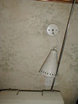 Lamp dangling from wire above TV that didn't seem to receive any stations.  