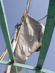 The "boom" is drawn up to furl the sail, rather than hoisting the whole thing