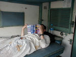 On this train, we traveled first class.  In the scale of things, that's really something like fourth class, coming below the three air conditioned classes.  But in first class there is a lockable door to the compartment.  There's nothing wrong with first class that a good scrubbing couldn't fix.  Unfortunately, there's no sign this car has seen soap and water since it was built.  Note that Mark has even wrapped his elbow in his sheetsack!