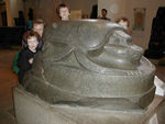 Four small people playing with one big dung beetle (200BC)